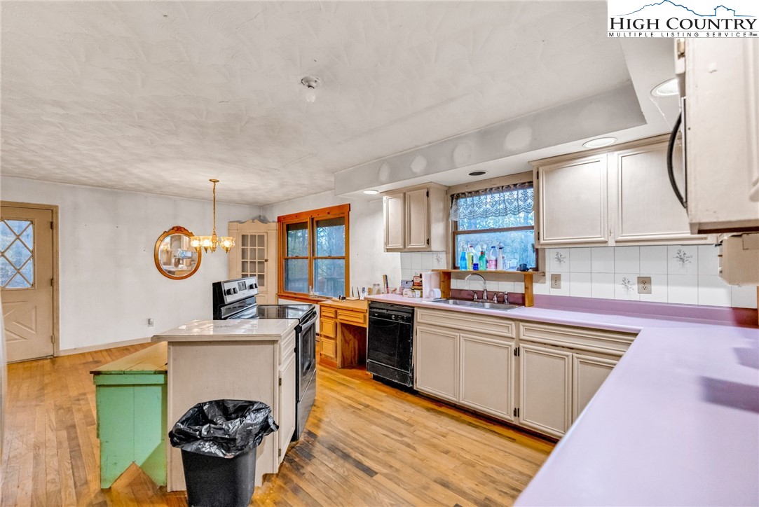 539 Four Coves Trail Crumpler, NC 28617 - Photo 14 of 37 a kitchen with a sink cabinets and window