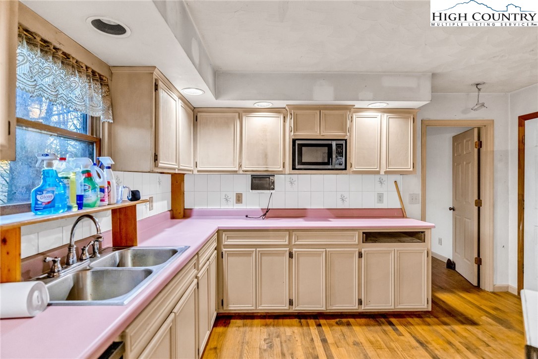 539 Four Coves Trail Crumpler, NC 28617 - Photo 15 of 37 a kitchen with a sink cabinets and window