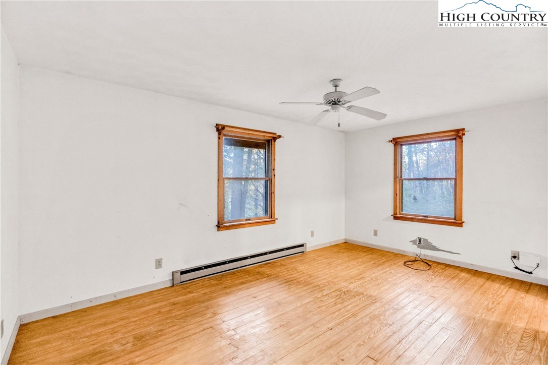 539 Four Coves Trail Crumpler, NC 28617 - Photo 17 of 37 an empty room with a window and a ceiling fan