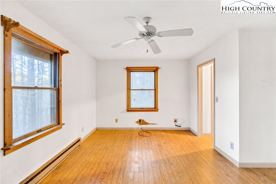 539 Four Coves Trail Crumpler, NC 28617 - Photo 18 of 37 a view of a bedroom with wooden floor and window