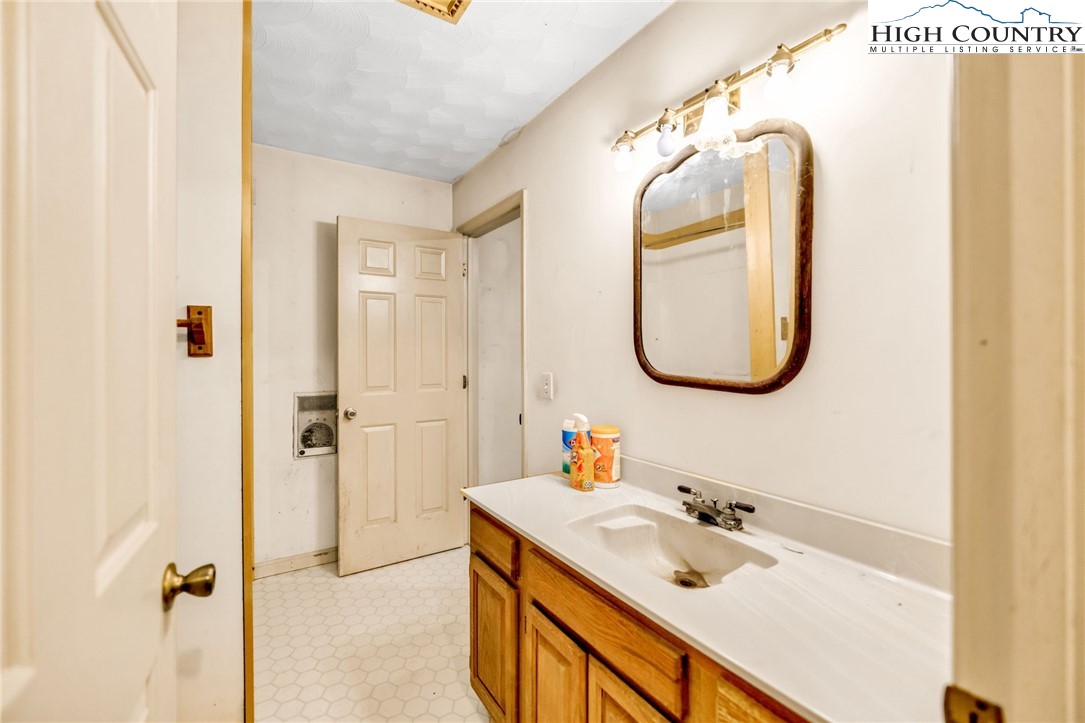 539 Four Coves Trail Crumpler, NC 28617 - Photo 20 of 37 a bathroom with a sink vanity granite tub and a mirror