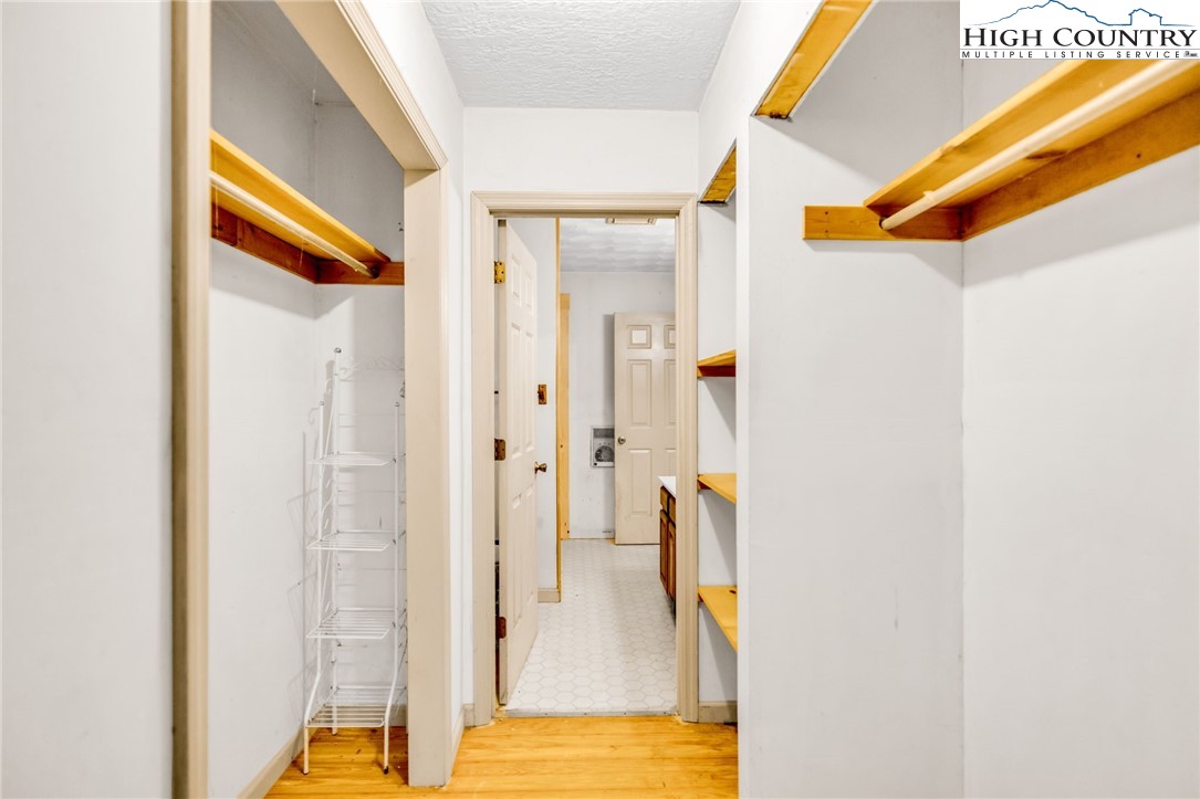 539 Four Coves Trail Crumpler, NC 28617 - Photo 21 of 37 a view of walk in closet with large window and wooden floor