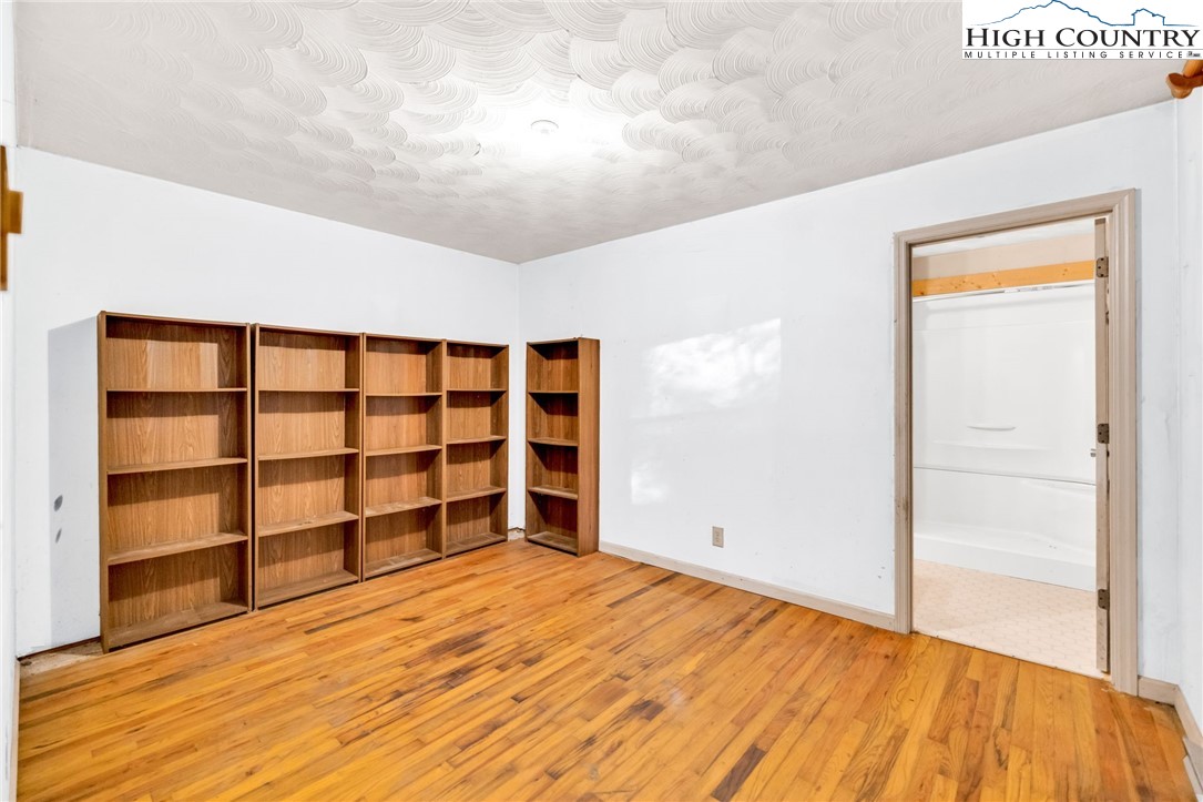 539 Four Coves Trail Crumpler, NC 28617 - Photo 22 of 37 a view of empty room with wooden floor and windows