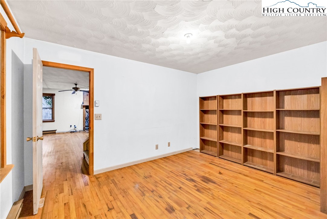 539 Four Coves Trail Crumpler, NC 28617 - Photo 23 of 37 a view of empty room with wooden floor and fan