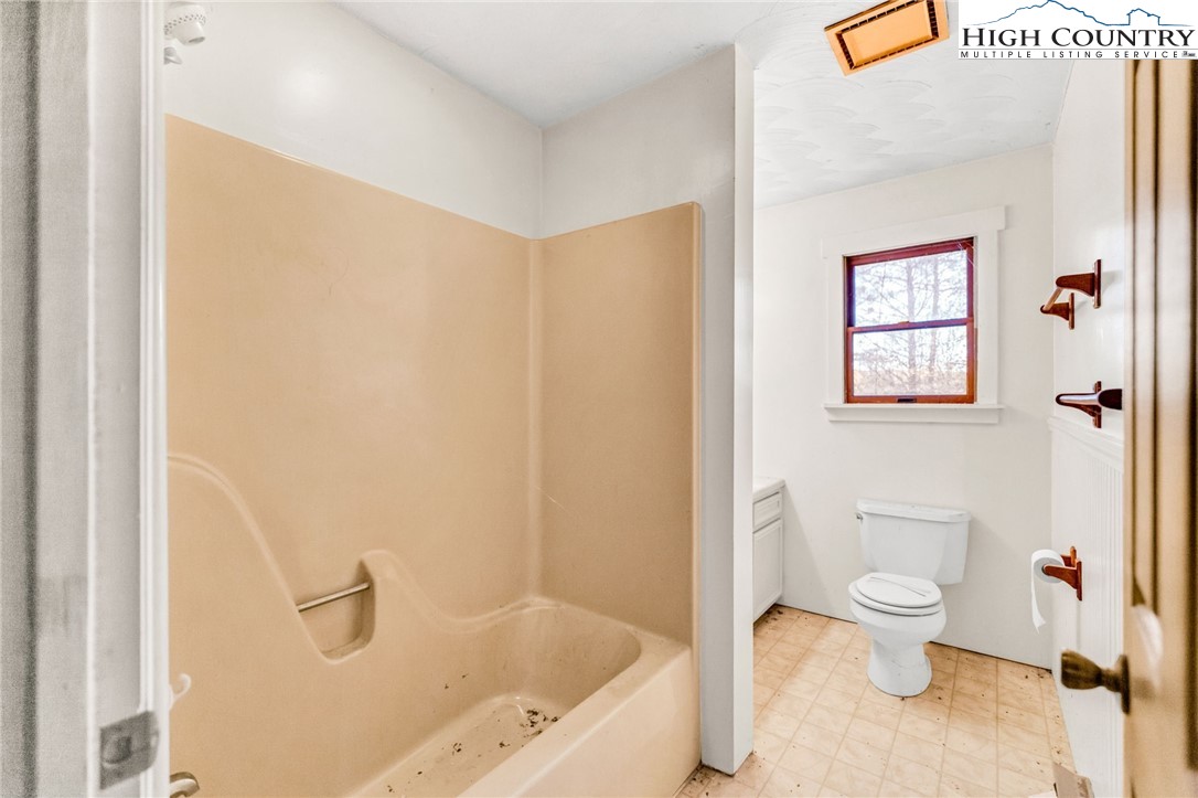 539 Four Coves Trail Crumpler, NC 28617 - Photo 29 of 37 a bathroom with a bathtub and a toilet