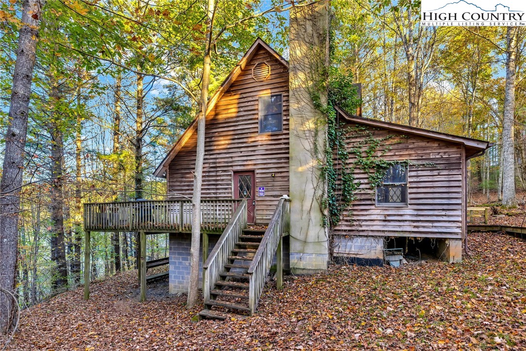539 Four Coves Trail Crumpler, NC 28617 - Photo 32 of 37 front view of a house with a bench