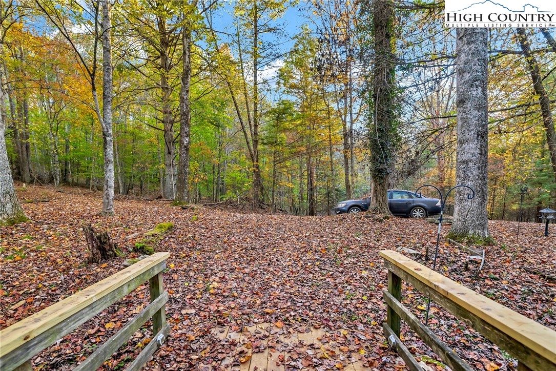 539 Four Coves Trail Crumpler, NC 28617 - Photo 6 of 37 a view of a yard with wooden fence
