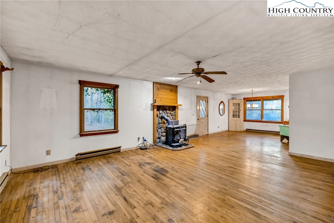 539 Four Coves Trail Crumpler, NC 28617 - Photo 9 of 37 a view of an empty room with window and wooden floor