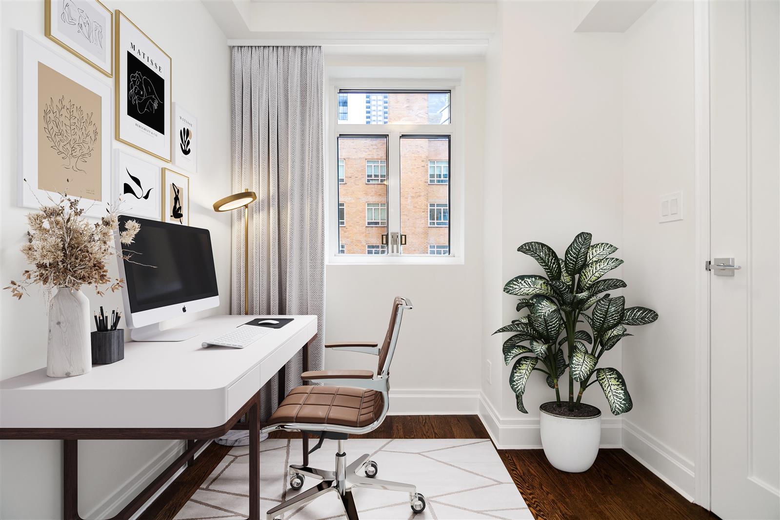 240 Central Park South, Unit 13GH Manhattan, NY 10019 - Photo 13 of 22 a view of a workspace with furniture and a potted plant