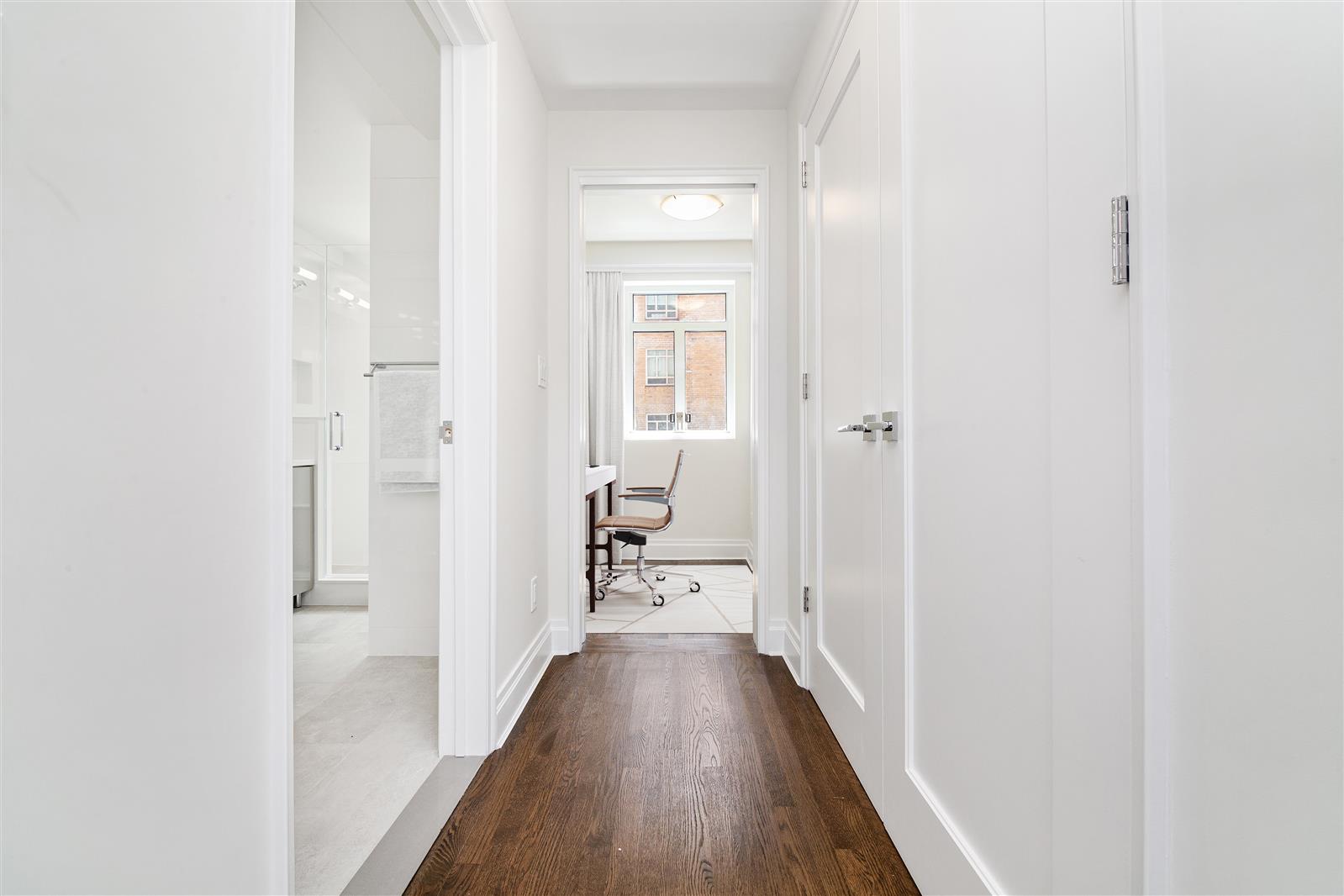 240 Central Park South, Unit 13GH Manhattan, NY 10019 - Photo 14 of 22 a view of a hallway with wooden floor and a bathroom