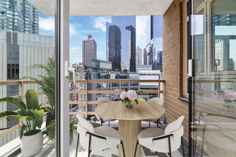 a balcony with table and chairs