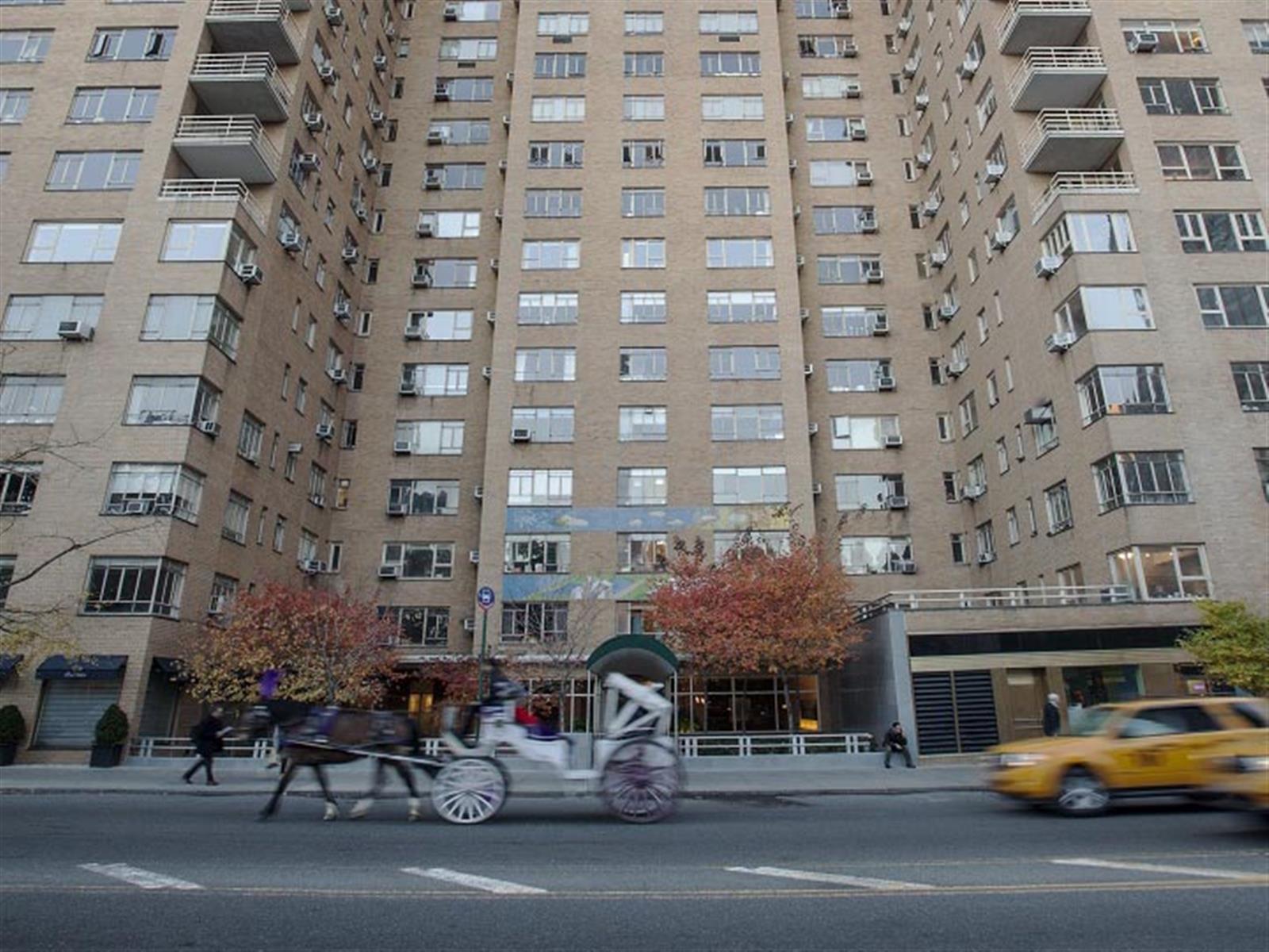 240 Central Park South, Unit 13GH Manhattan, NY 10019 - Photo 22 of 22 a city street lined with buildings and cars