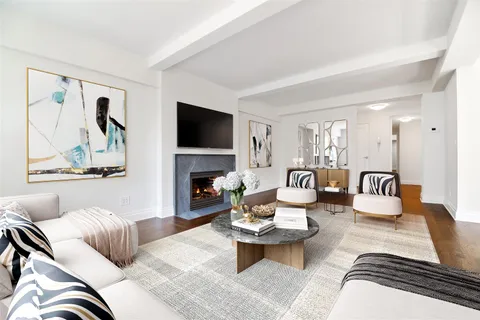a living room with furniture a rug and a flat screen tv