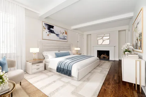 a spacious bedroom with a large bed and a fireplace