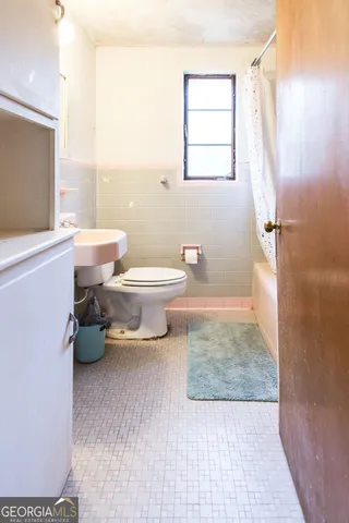 a bathroom with a toilet a sink and a bathtub