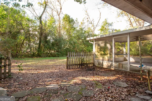 a backyard of a house with a large tree