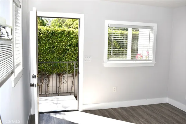 an empty room with wooden floor and a window
