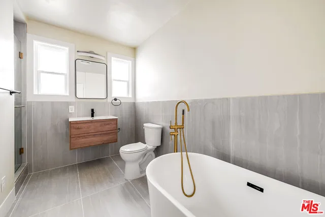 a bathroom with a sink a toilet and bathtub