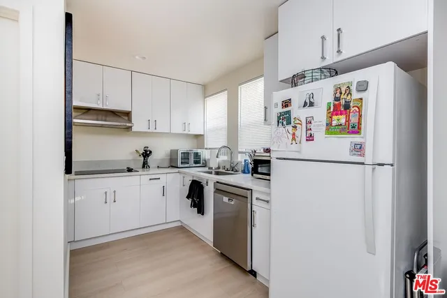 a white refrigerator freezer sitting inside of a kitchen