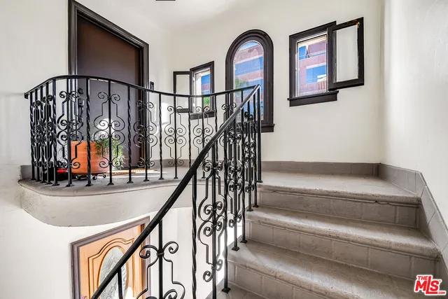 a view of staircase with lots of frames on wall and frames on wall