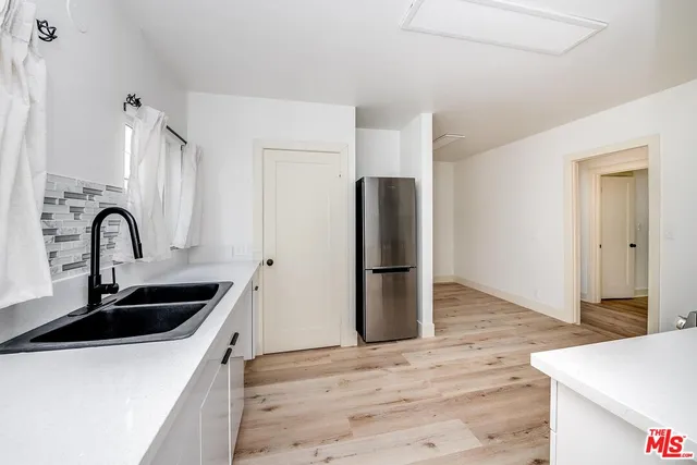 a kitchen with stainless steel appliances a sink and a refrigerator