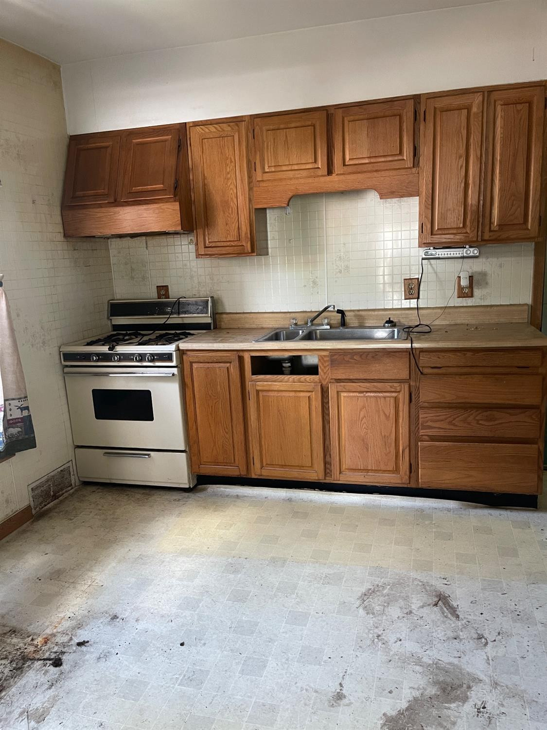 1210 Harrison Street Lowell, IN 46356 - Photo 2 of 11 a kitchen with granite countertop a stove top oven sink and cabinets