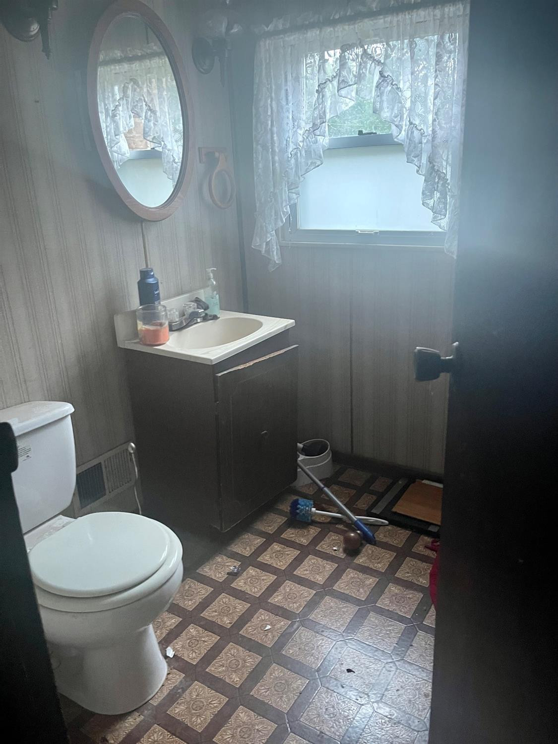 1210 Harrison Street Lowell, IN 46356 - Photo 9 of 11 a bathroom with a toilet sink and mirror