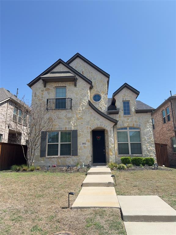 1052 Margo Drive Allen, TX 75013 - Photo 1 of 1 French country inspired facade with stone siding, a balcony, fence, and a front lawn