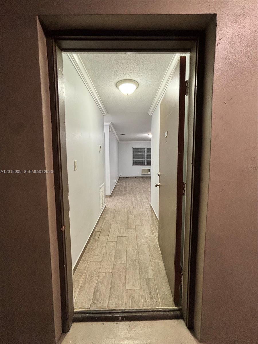 1480 East Sample Road, Unit 209 Pompano Beach, FL 33064 - Photo 8 of 24 a view of a hallway with wooden floor
