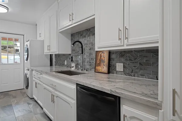 a kitchen with a refrigerator and a sink