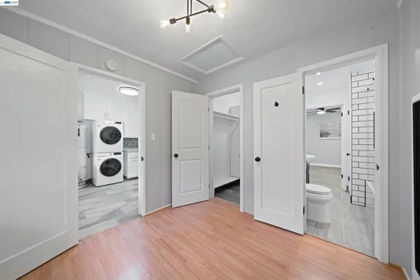 a view of a livingroom with wooden floor and closet area
