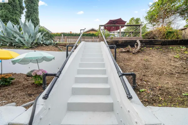 a view of a house with backyard and sitting area