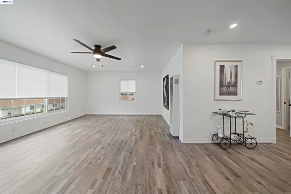 a view of a livingroom with a hardwood floor and a ceiling fan