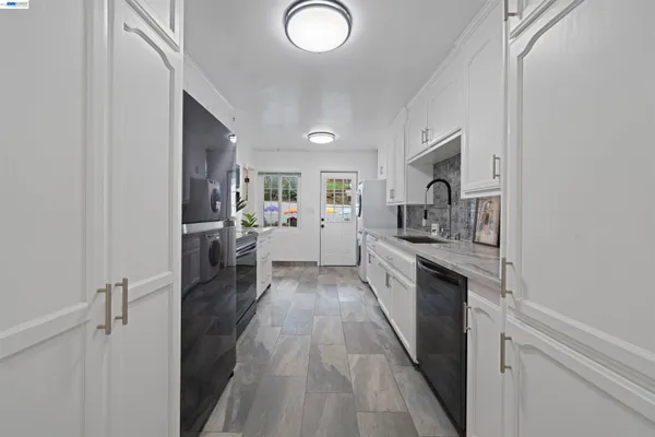 a kitchen with stainless steel appliances granite countertop a sink and dishwasher