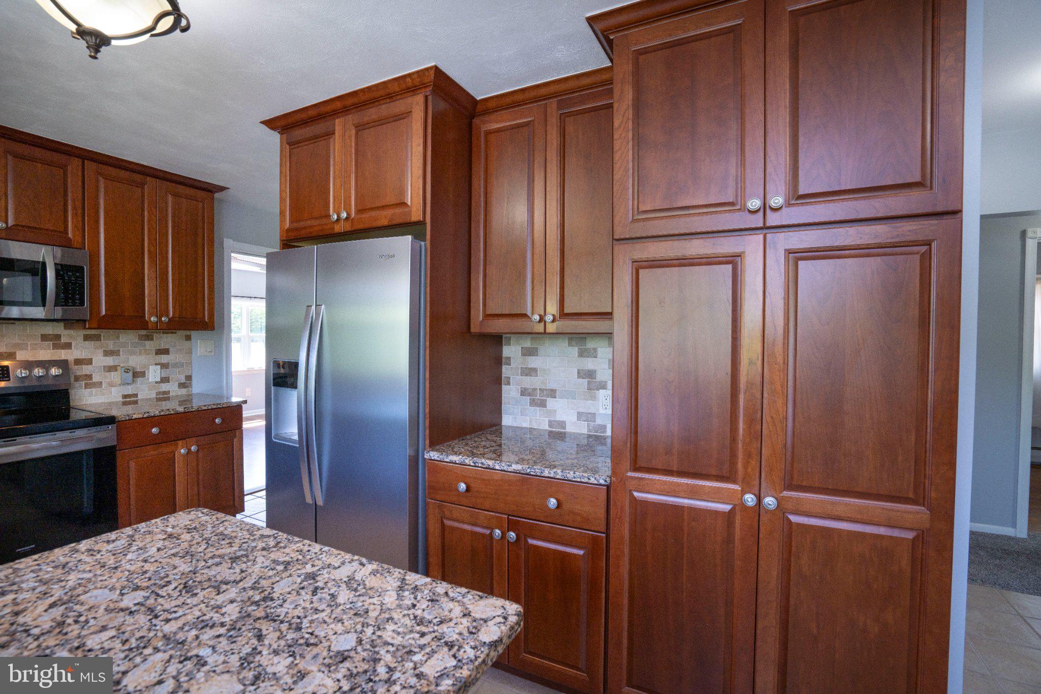 1639 Houserville Road State College, PA 16801 - Photo 21 of 54 Modern kitchen with rich wood cabinetry.