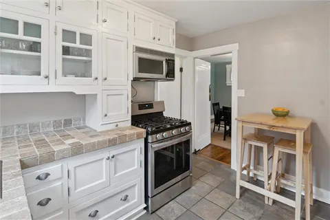 a kitchen with cabinets appliances and a window