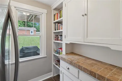 a kitchen with a refrigerator and a window