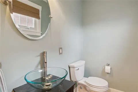 a bathroom with a toilet and a mirror