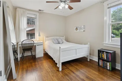 a bedroom with a bed and a chandelier