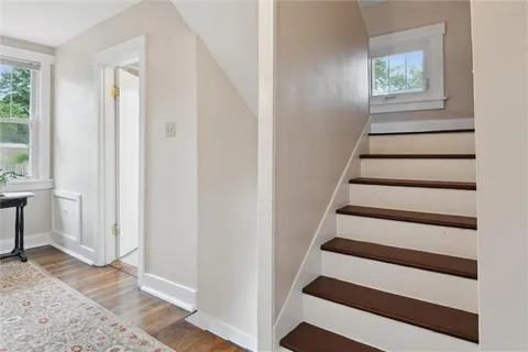 a view of entryway with wooden floor and front door