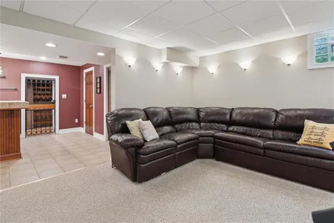 a living room with furniture and kitchen view