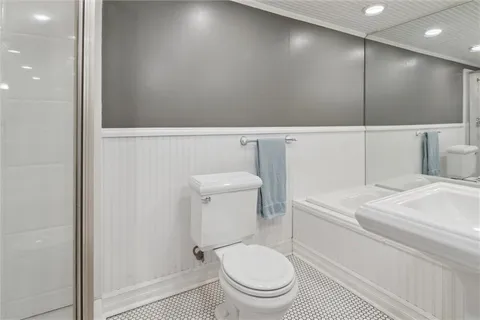 a bathroom with a toilet a sink and a shower