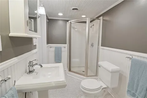 a bathroom with a sink toilet and shower