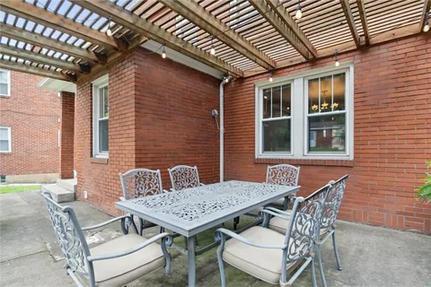 a view of a patio with table and chairs and potted plants