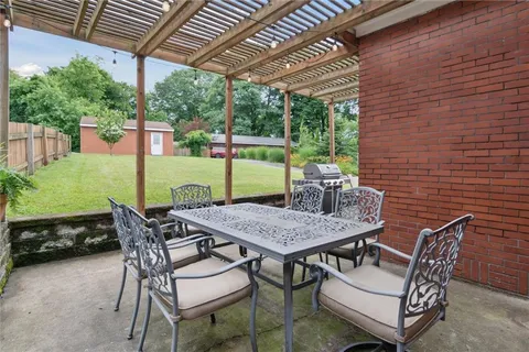 a view of a patio with a table and chairs