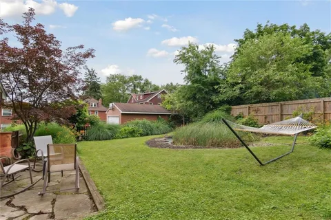 a view of a backyard with table and chairs and potted plants