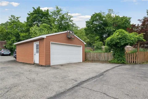 a view of a house with a yard and garage