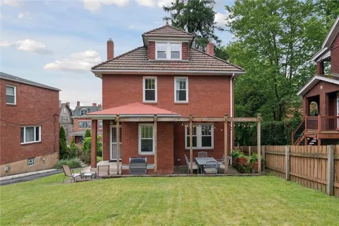 a front view of a house with a yard and porch
