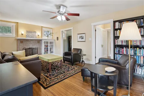 a living room with furniture fireplace and a table