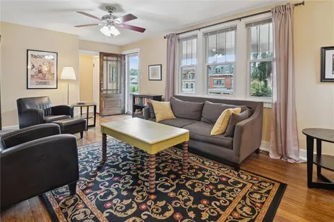 a living room with furniture and wooden floor